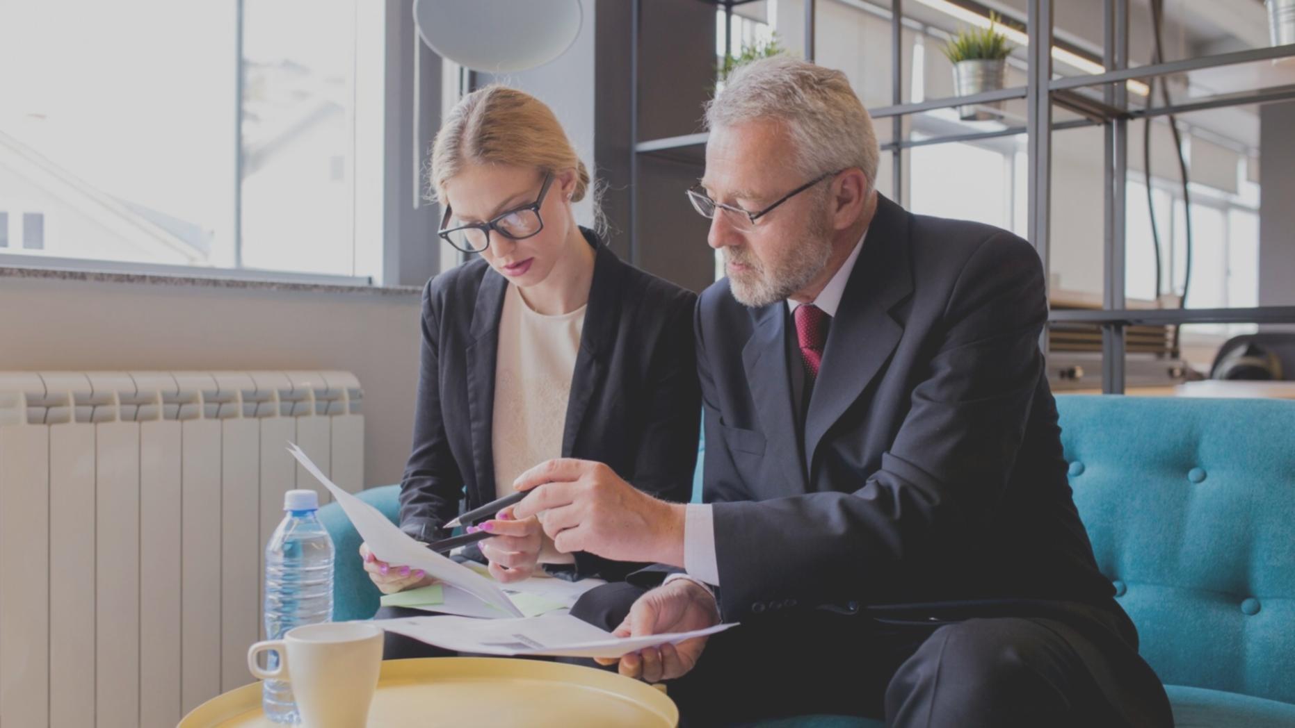 Small group workshop session at verisorquix's Blacktown office showing business owners reviewing budget documents and discussing surplus management strategies