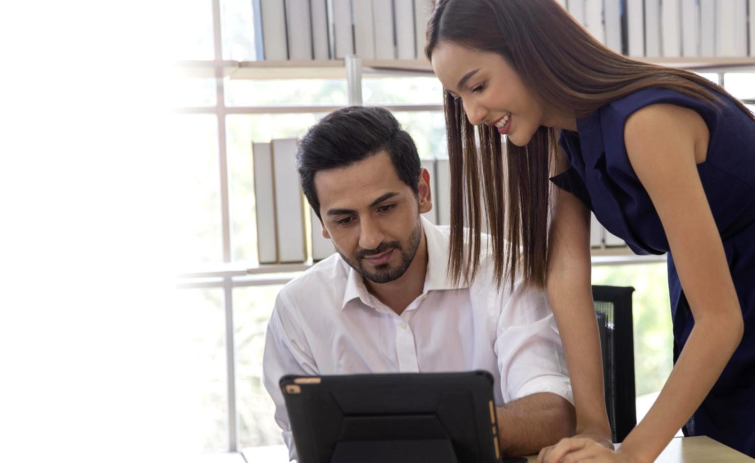 Financial advisers collaborating on client surplus management strategies during partnership meeting